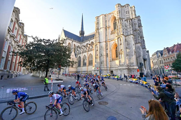 A group of people riding bikes in front of a buildingDescription automatically generated with low confidence