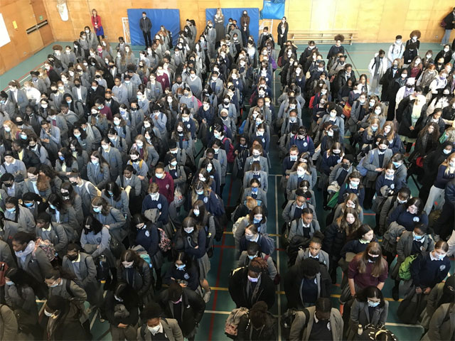A large group of people in a roomDescription automatically generated with medium confidence