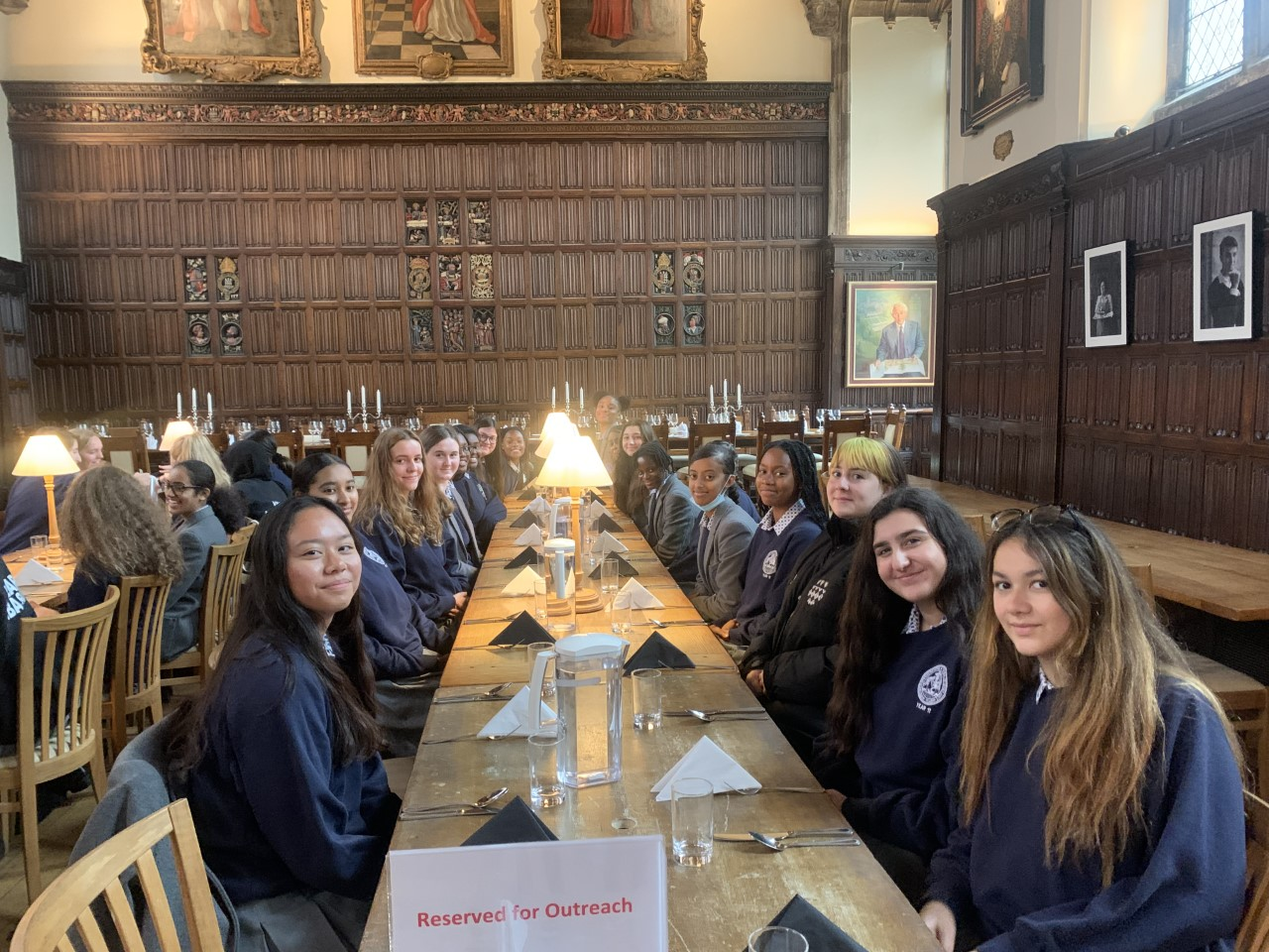 A group of people sitting at a table with candlesDescription automatically generated with low confidence
